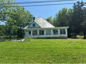 Charming single story home with large lawn, multiple paned windows and lush trees at 391 Rudy York Nw Rd, Cartersville, GA 30121