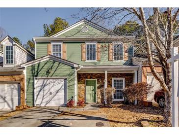 Charming townhome featuring stone accents, a cozy front porch, and an attached garage at 6269 Colonial Vw, Fairburn, GA 30213