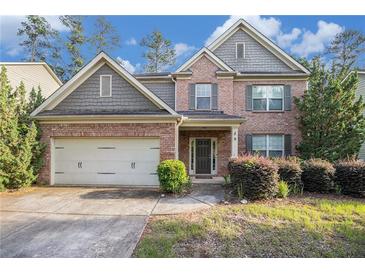 Charming two-story brick home with a well-maintained lawn and attached two-car garage at 4889 Arbor View Nw Pkwy, Acworth, GA 30101