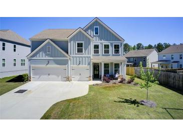 Charming two-story home with a manicured lawn, two-car garage, and inviting front porch at 42 Citrine Way, Acworth, GA 30101
