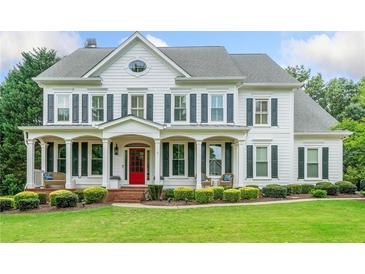 Elegant two-story white home with black shutters, inviting front porch, and well-manicured lawn at 6219 Creekstone Path, Cumming, GA 30041