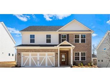 Charming two-story home with brick and siding, complemented by a two-car garage and well-manicured landscaping at 1619 Tide Mill Road, Cumming, GA 30040