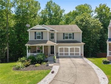 Charming two-story home with a well-manicured lawn and an attached two-car garage at 3420 Griffin Way, Cumming, GA 30040