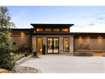 Stunning modern home featuring a unique stone facade, a courtyard, and sophisticated landscaping at 2746 Emerald Dr, Jonesboro, GA 30236