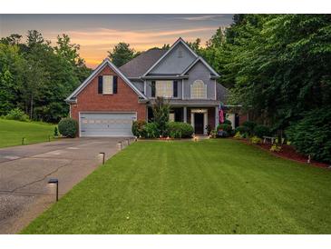 Charming two-story brick home with a manicured lawn and attached two-car garage at 5928 Edenfield Nw Dr, Acworth, GA 30101