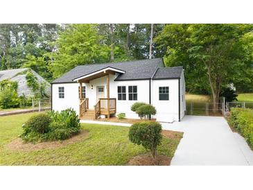 Charming renovated home with new landscaping, gray roof, white siding, and an inviting front porch at 1111 Edgefield Sw Dr, Atlanta, GA 30310