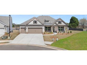 Charming single-Gathering home with a three-car garage and well-manicured lawn in a desirable community at 1609 Tielman Way, Snellville, GA 30078
