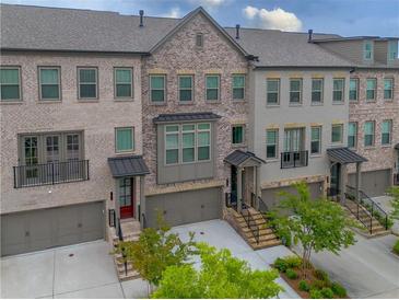 Charming townhome exterior with brick facade, inviting entrances, and well-maintained landscaping at 3 Hundley Ln, Roswell, GA 30076