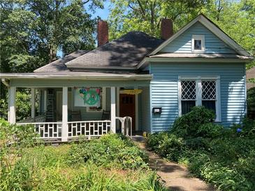 Charming blue home with a cozy front porch and a lovely landscaped yard at 782 Marion Se Ave, Atlanta, GA 30312