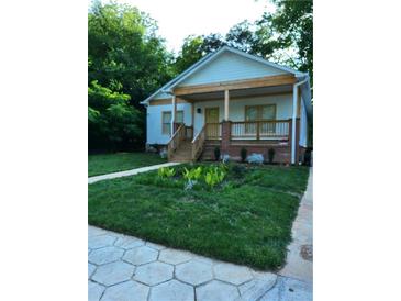 Charming single-story home with a welcoming front porch and meticulously landscaped front yard at 1167 Oakland Sw Dr, Atlanta, GA 30310