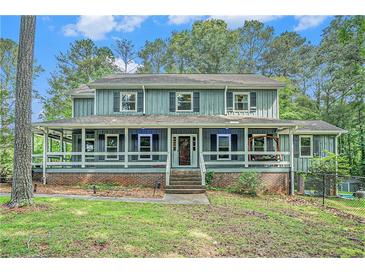 Charming two-story home with a welcoming front porch and well-maintained landscaping at 3392 Inns Brook Way, Snellville, GA 30039