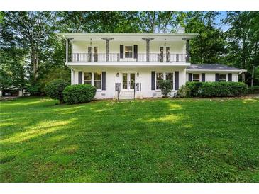 Charming two-story home with a second story balcony and a lush green lawn at 5290 River Mill Cir, Marietta, GA 30068