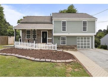 Charming two-story home featuring a landscaped front yard and a welcoming front porch at 1491 Black Hickory Pl, Norcross, GA 30093