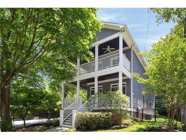 Charming two-story home featuring double porches, white railings, gray siding, and professional landscaping at 1003 North Ne Ave, Atlanta, GA 30306