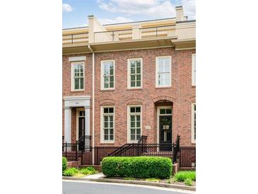 Charming brick townhome with a rooftop deck, front garden, and welcoming entrance at 1211 Riverscall Ln, Atlanta, GA 30339