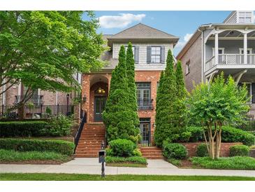Charming brick home with manicured landscaping, mature trees and inviting curb appeal at 1220 State Nw St, Atlanta, GA 30318