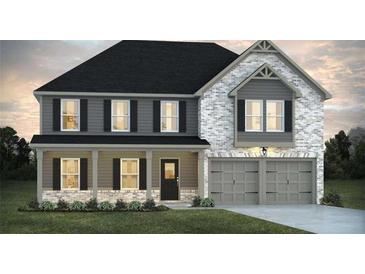 Charming two-story home featuring a brick and siding facade, covered porch, and an attached two-car garage at 246 Crabapple Rd, Mcdonough, GA 30253