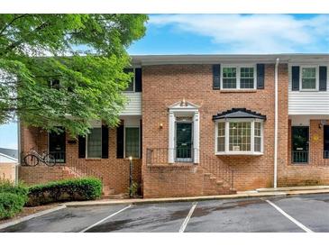 Charming brick townhome with black shutters, landscaping, and convenient parking at 6520 Roswell Rd # 48, Atlanta, GA 30328