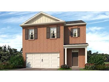 Charming brick two-story home featuring an attached two car garage and a welcoming front entryway at 3044 Manor Hill Pl, Union City, GA 30291