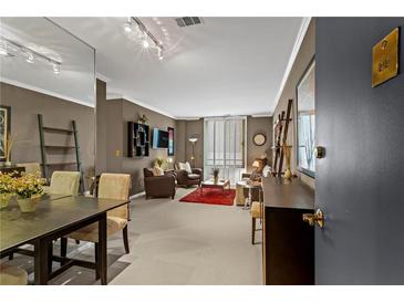Inviting living room with dining area, comfortable seating, and lots of natural light at 1421 Peachtree Ne St # 212, Atlanta, GA 30309