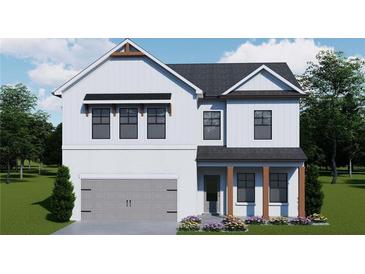 Charming two-story home featuring white siding, brick accents, a gray garage door, and a beautifully landscaped front yard at 408 Westmarch Cir, Loganville, GA 30052