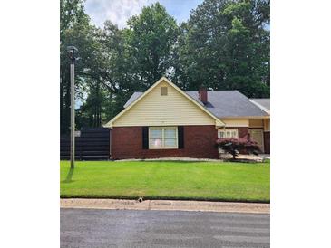 Charming brick home with a well-maintained front yard and mature trees at 6210 Douglas Manor Ct, Douglasville, GA 30134