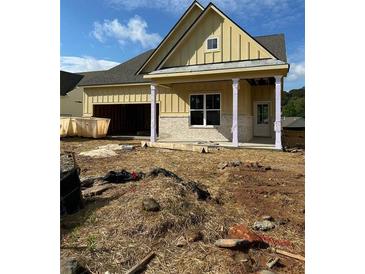 New construction home featuring a covered porch with columns, stone accents, and an attached garage at 2004 Homestead Ct, Woodstock, GA 30189
