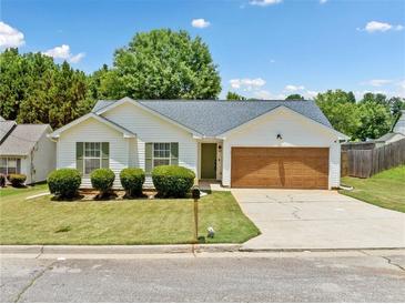Charming single-story home with manicured lawn and inviting curb appeal on a sunny day at 3020 River Oak Mews, Decatur, GA 30034