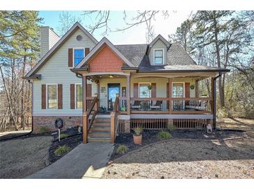 Charming home with a welcoming front porch, wooden pillars and shutters, set in a serene, wooded neighborhood at 9001 E Carroll Rd, Winston, GA 30187