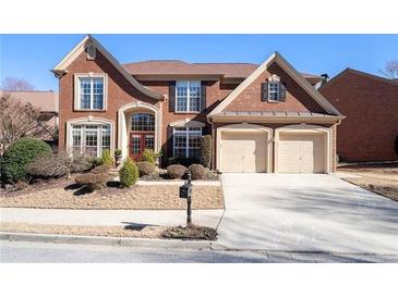 Charming two-story brick home with a two-car garage and landscaped front yard on a sunny day at 3505 Belridge Ln, Smyrna, GA 30080