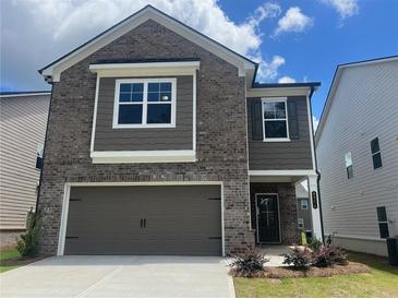 Charming two-story home with a brick facade, two-car garage and welcoming front entrance at 4554 Eastbrook Pl, Snellville, GA 30039