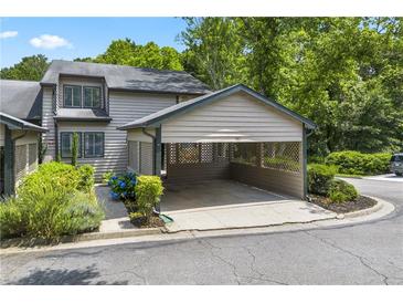 Charming townhome featuring a covered carport and manicured landscaping at 500 Gardenia Ln, Marietta, GA 30068