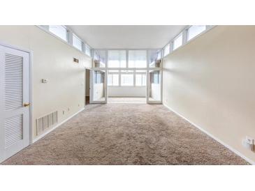 Bright living room with large windows and neutral carpet offers plenty of natural light at 346 Carpenter Dr # 70, Atlanta, GA 30328