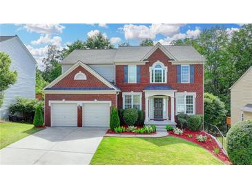 Beautiful two-story brick home with a well-manicured lawn and a two-car garage at 475 Bayswater Way, Suwanee, GA 30024