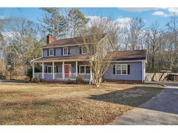 Charming two-story home featuring a cozy front porch and a red front door at 130 Thornton Dr, Fayetteville, GA 30214