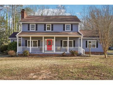 Charming two-story home with a welcoming front porch and a vibrant red front door at 130 Thornton Dr, Fayetteville, GA 30214
