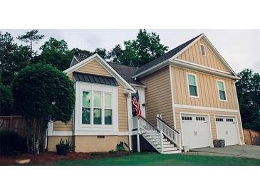 Charming two-story home features a two car garage, stairs to the front door, and a well-manicured lawn at 2193 Kildare Nw Way, Kennesaw, GA 30152