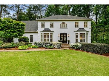 Charming two-story traditional home with manicured lawn, lush landscaping, and stately front entrance at 3275 Lord N Lady Ln, Alpharetta, GA 30022
