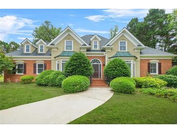 Charming brick and stucco home with manicured lawn and mature landscaping at 110 Glen Eagle Way, Mcdonough, GA 30253