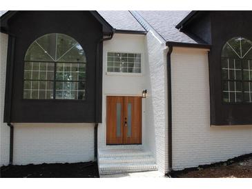 Stunning two-story home with a stylish front entrance and beautiful landscaping at 4220 Glad Morning Dr, College Park, GA 30349