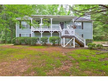Charming front exterior with covered porch and well-maintained landscaping at 476 Cody Ln, Douglasville, GA 30134