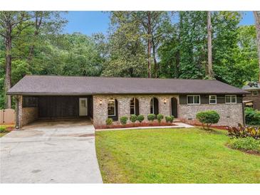 Charming single-story home with a well-manicured front yard and a covered carport at 2771 Smithsonia Way, Tucker, GA 30084