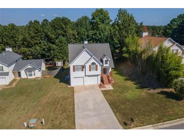 Charming two-story home with a two-car garage, landscaped yard, and a welcoming front entrance at 10074 Tara Glynn Dr, Hampton, GA 30228