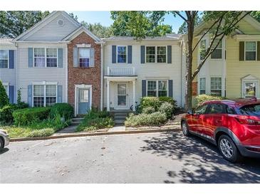Charming townhome with light siding, blue shutters, and well-maintained landscaping at 10900 Wittenridge Dr # C7, Alpharetta, GA 30022