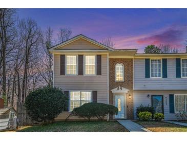 Charming two-story townhome with a well-maintained front yard and inviting entrance at 4211 Wingfoot Ct, Decatur, GA 30035
