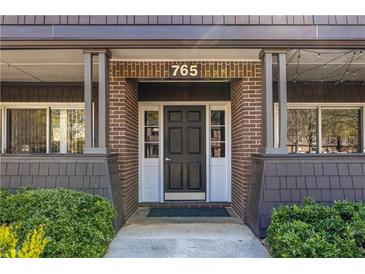 Charming home entrance with brick facade, black door, and visible house number at 765 Houston Mill Ne Rd # 7, Atlanta, GA 30329
