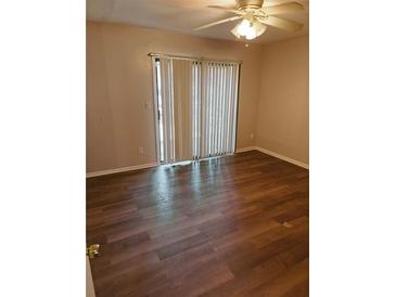 Spacious bedroom featuring wood floors, and a ceiling fan to maintain a comfortable home at 2751 Penwood Pl, Lithonia, GA 30058