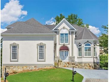 Charming two-story home featuring detailed architectural elements and a manicured front lawn at 4770 Powers Park Ne Ct, Marietta, GA 30067