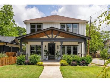 Charming two-story home with modern farmhouse design, inviting front porch, and well-maintained landscaping at 1354 Mcpherson Se Ave, Atlanta, GA 30316