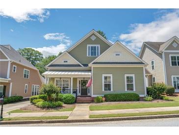 Charming two-story home with a well-manicured lawn, lush landscaping and inviting front porch at 125 Rabbits Run, Fayetteville, GA 30215
